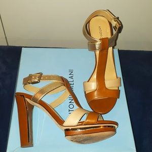 Antonio Melani nude and gold heel with ankle strap.